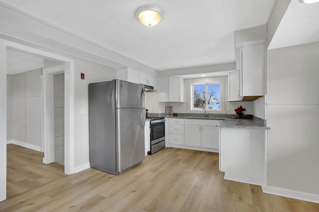 12 Stebbins Street Chicopee, MA 01020 - Photo 9 of 39 a kitchen with a refrigerator and a sink