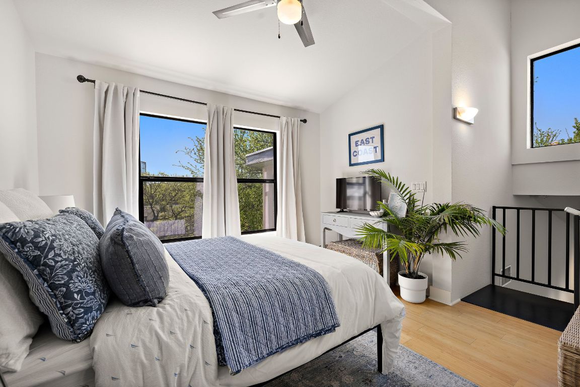 907 Duncan Lane, Unit 302 Austin, TX 78705 - Photo 19 of 24 a bedroom with a bed and a large window