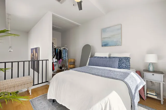 a bedroom with a bed and a large window