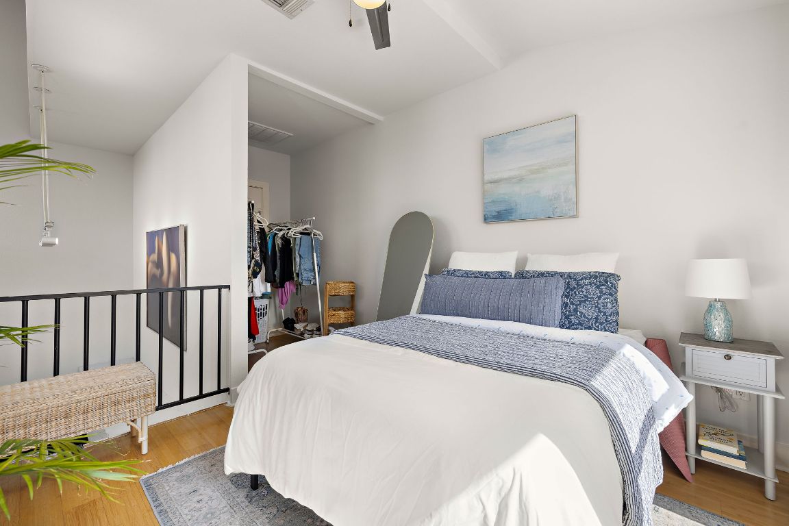 907 Duncan Lane, Unit 302 Austin, TX 78705 - Photo 20 of 24 a bed room with a bed and a painting on the wall