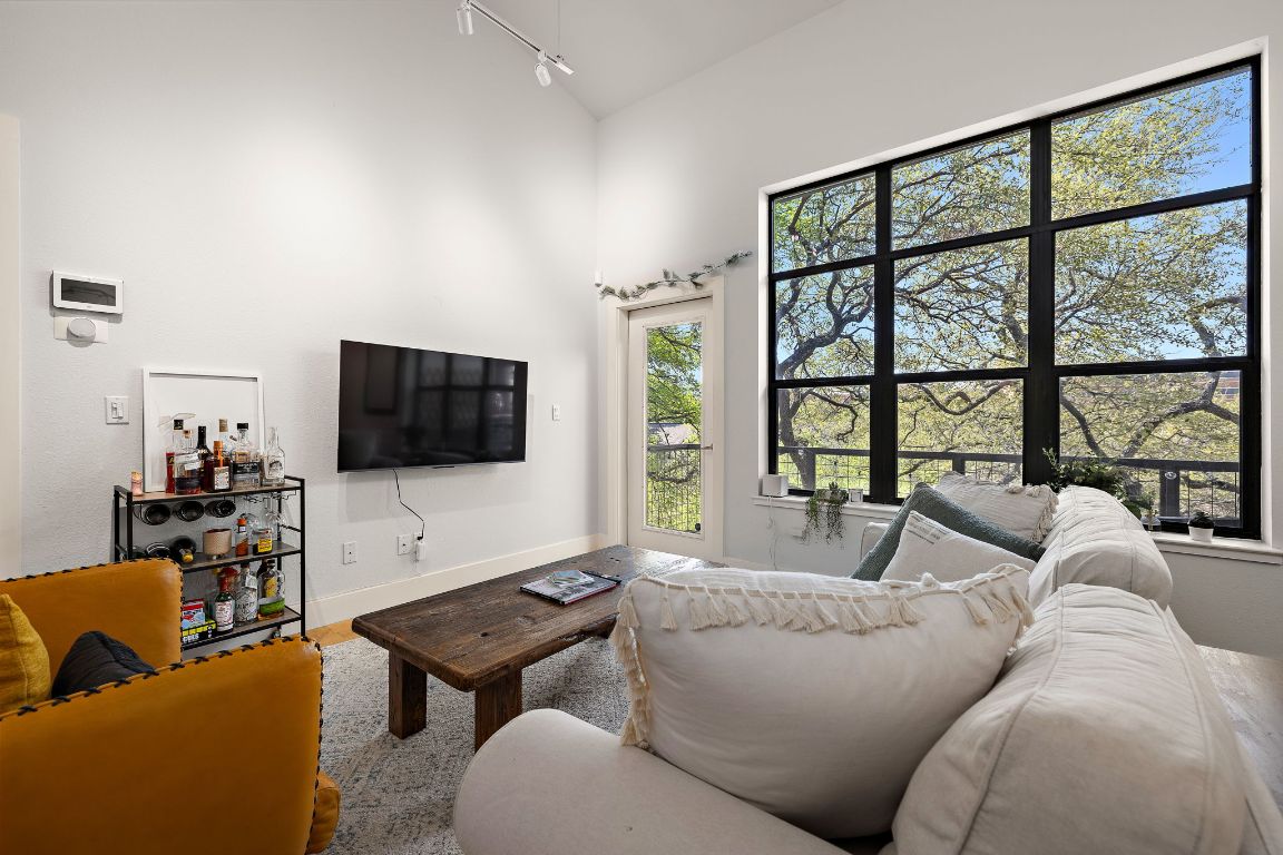 907 Duncan Lane, Unit 302 Austin, TX 78705 - Photo 5 of 24 a living room with furniture and a flat screen tv