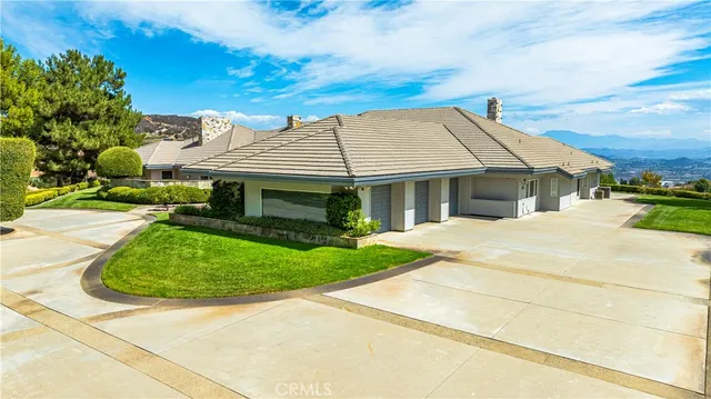 a kitchen with stainless steel appliances granite countertop a sink a counter space and a view of living room