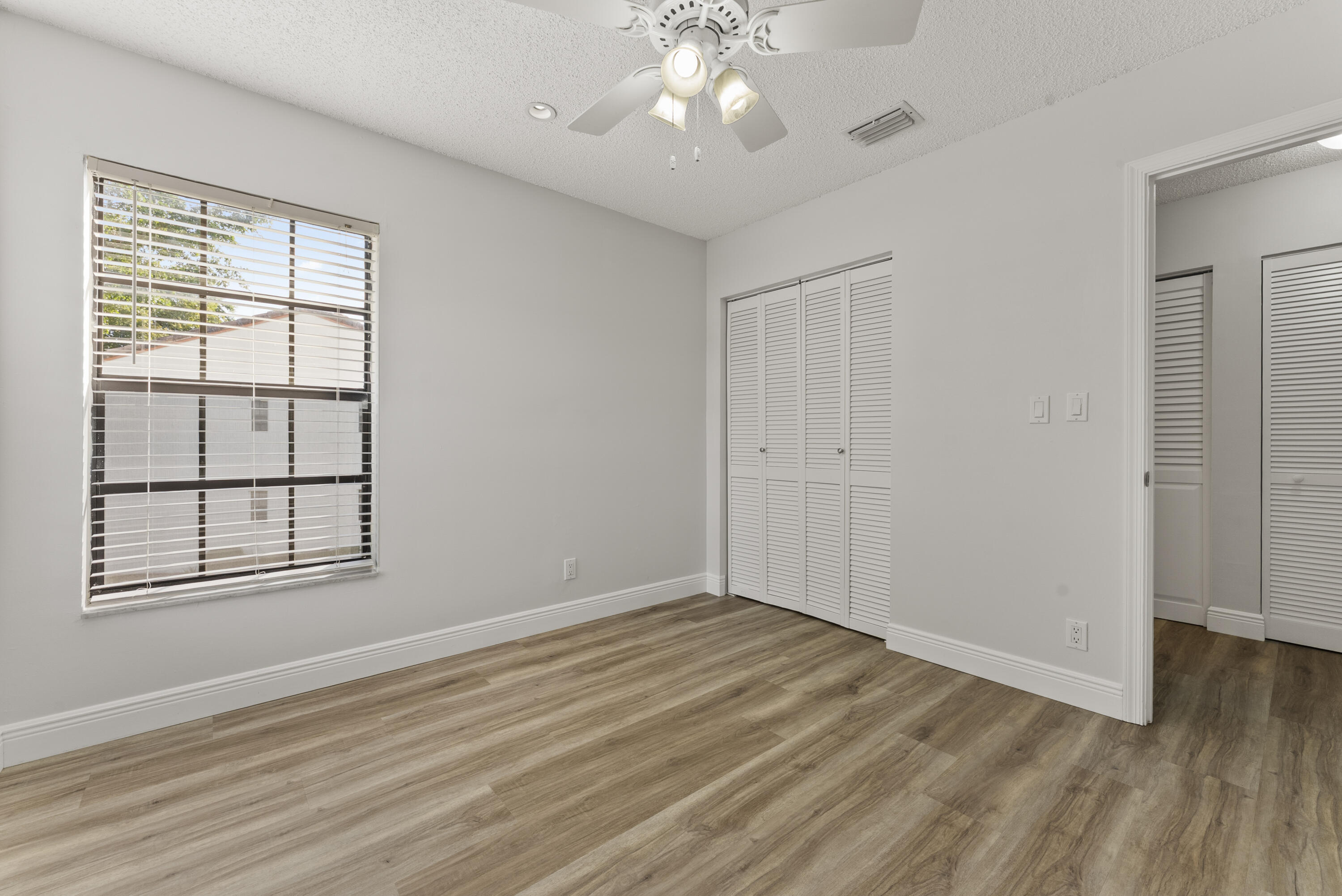 2900 Olivewood Terrace, Unit 2010 Boca Raton, FL 33431 - Photo 12 of 22 wooden floor in an empty room with a window