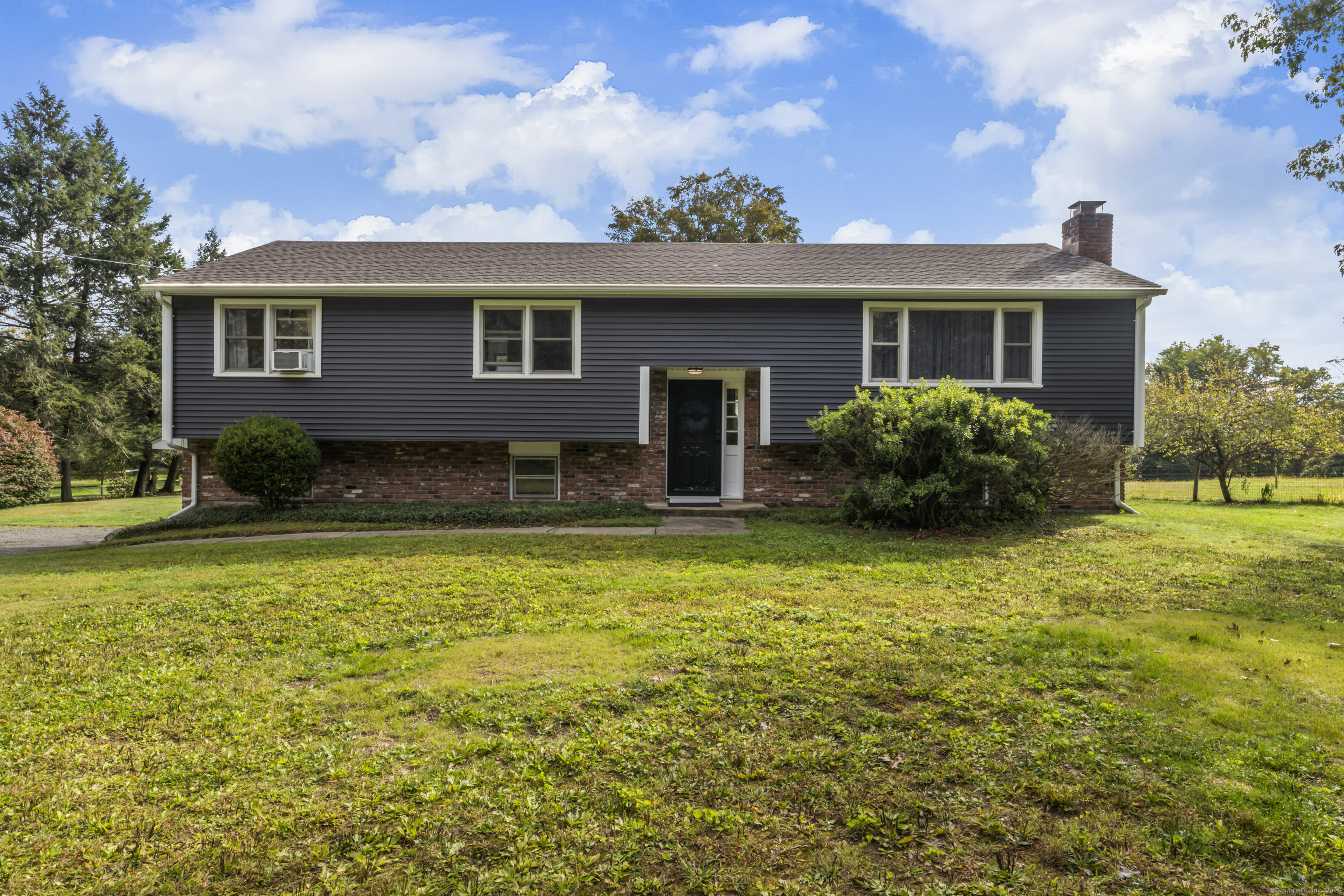 a view of a house with a swimming pool and a yard