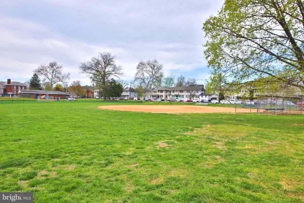 a view of yard with swimming pool and green space