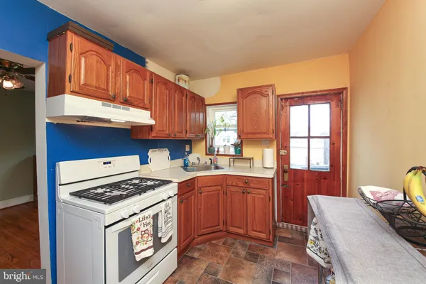 a kitchen with a stove a sink dishwasher and a refrigerator