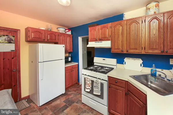 a kitchen with stainless steel appliances granite countertop a refrigerator stove a sink dishwasher and a microwave oven