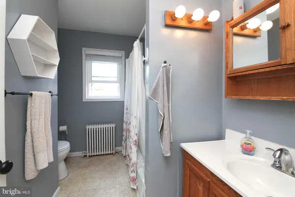 a bathroom with a sink vanity and a mirror