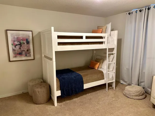 a bedroom with a bed and a chair