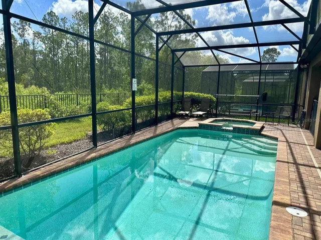 a backyard of a house with garden and outdoor seating