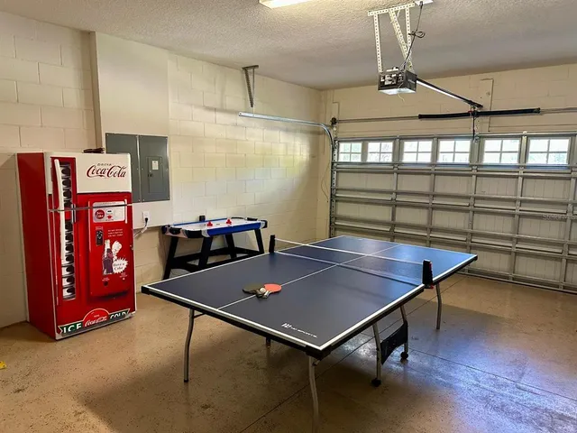 a room with furniture pool table and windows