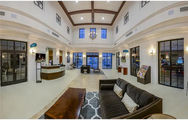 a living room with fireplace furniture and a chandelier