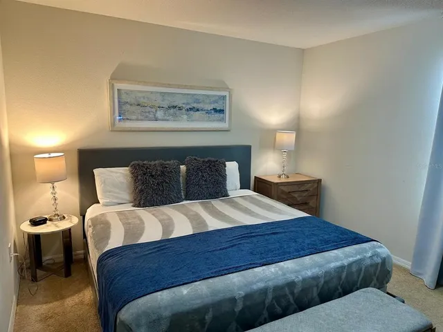 a bedroom with a bed and a night stand