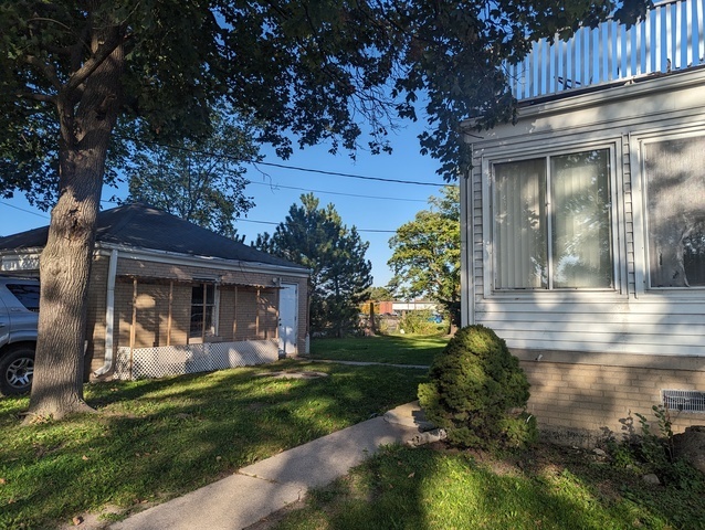 6950 Dempster Street Morton Grove, IL 60053 - Photo 3 of 21 a front view of a house with garden