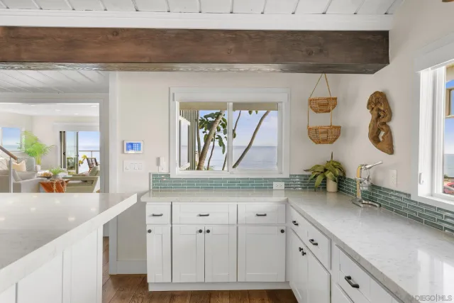 a kitchen with sink and cabinets