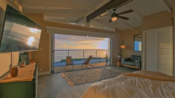 a bedroom with a bed and a large window