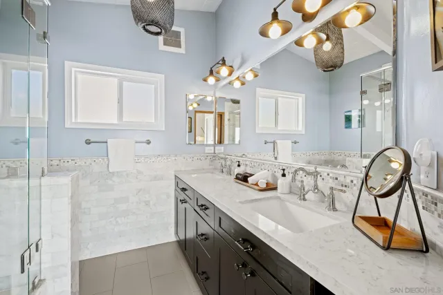 a bathroom with a sink vanity and a mirror