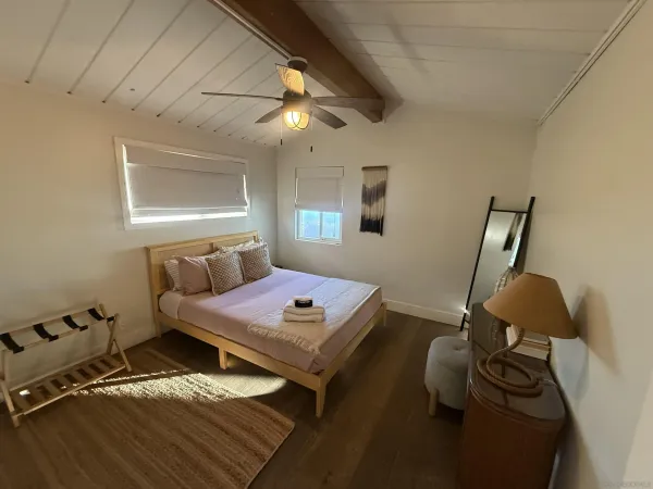 a bedroom with furniture and a window