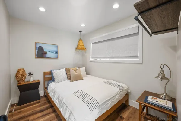 a bedroom with a bed and wooden floor
