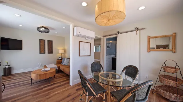 a dining room with furniture and wooden floor