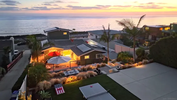 a front view of a building with a garden