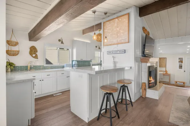 a kitchen with cabinets and chairs