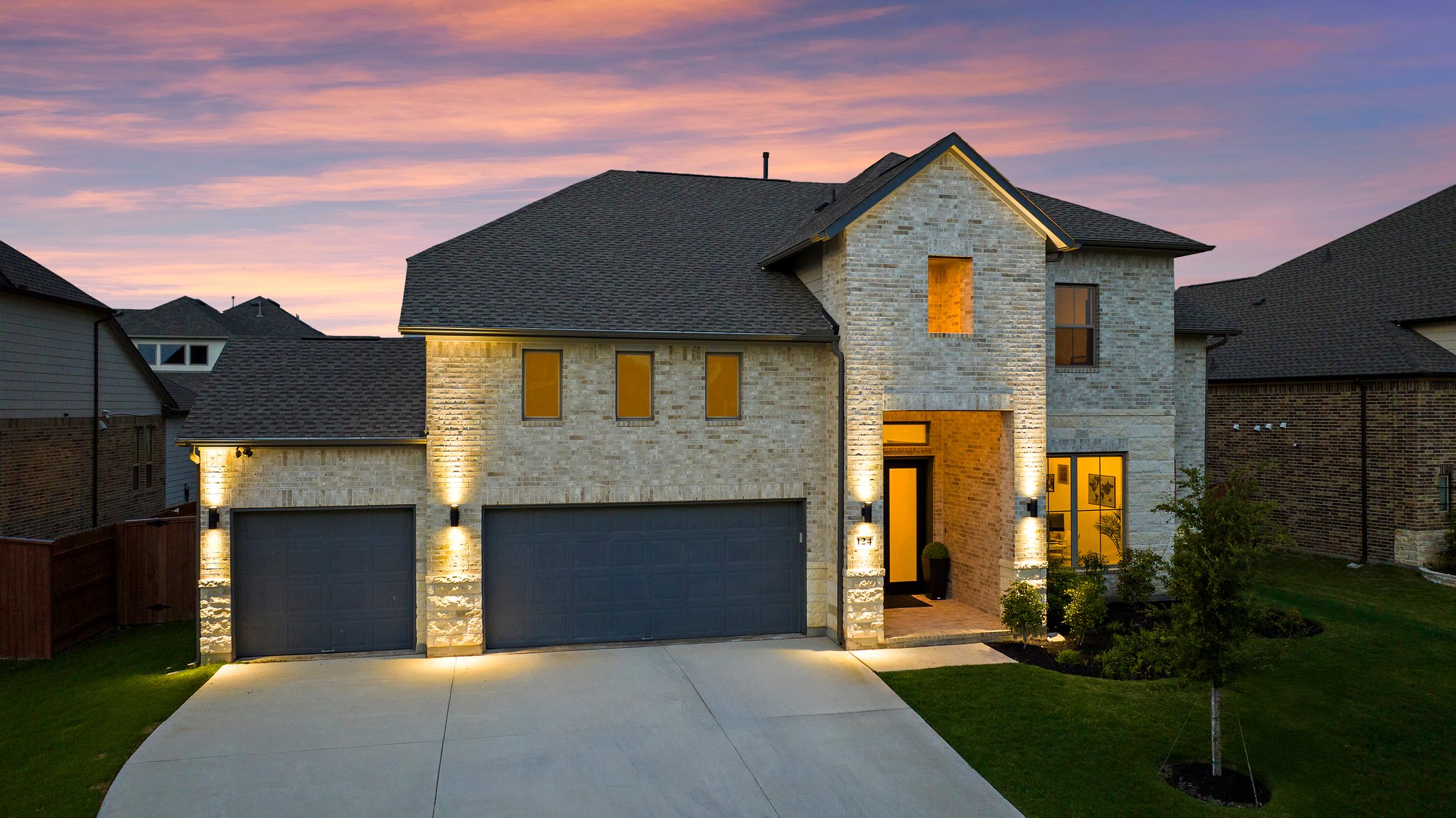 a front view of a house with a yard and garage