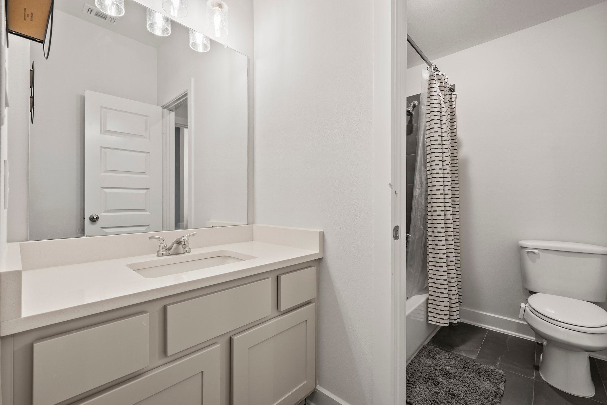 124 Low River Lane Georgetown, TX 78628 - Photo 32 of 39 a bathroom with a toilet a sink and mirror