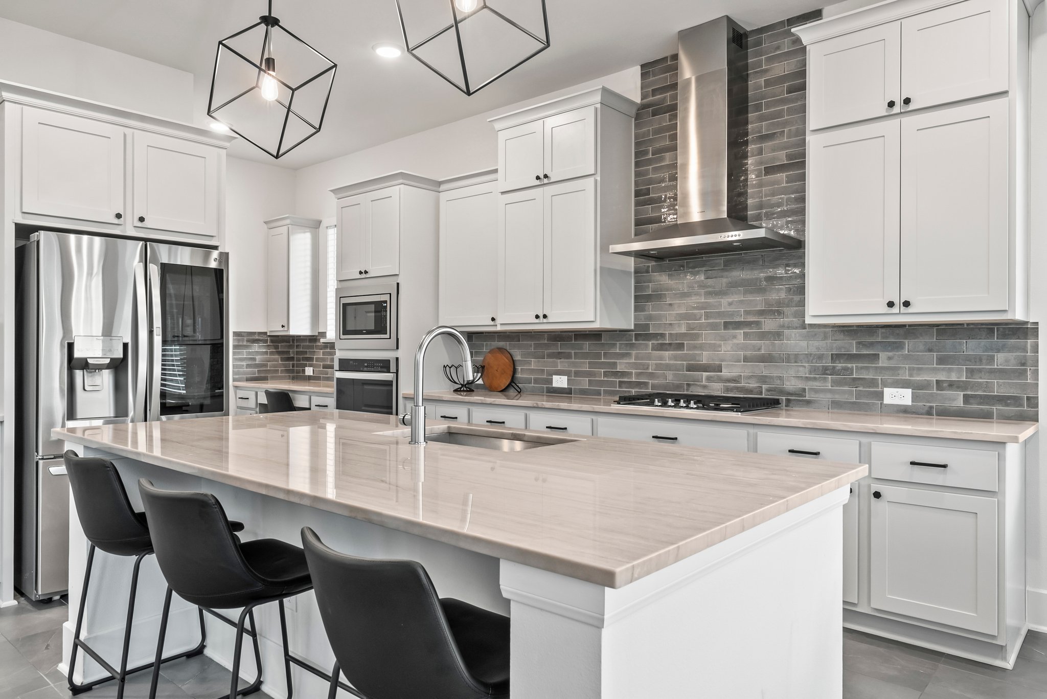 124 Low River Lane Georgetown, TX 78628 - Photo 9 of 39 a kitchen with stainless steel appliances white cabinets and wooden floor