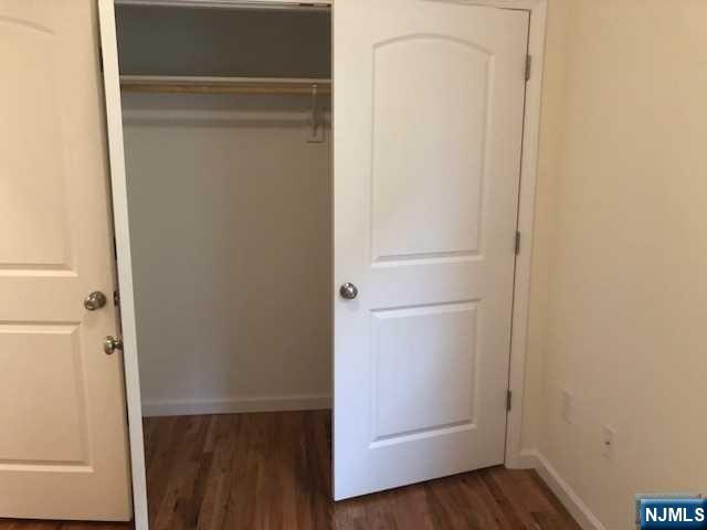 426 Jersey Street, Unit 1 GROUND Harrison, NJ 07029 - Photo 12 of 17 a view of walk in closet with wooden floor