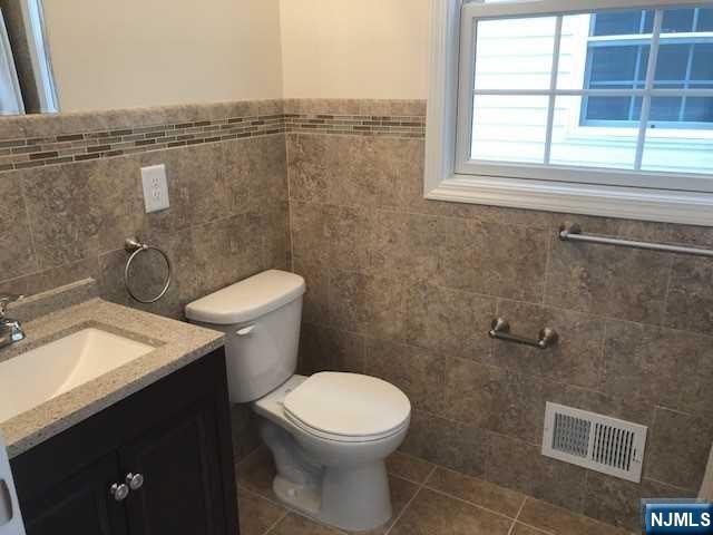426 Jersey Street, Unit 1 GROUND Harrison, NJ 07029 - Photo 9 of 17 a bathroom with a toilet a sink and a window