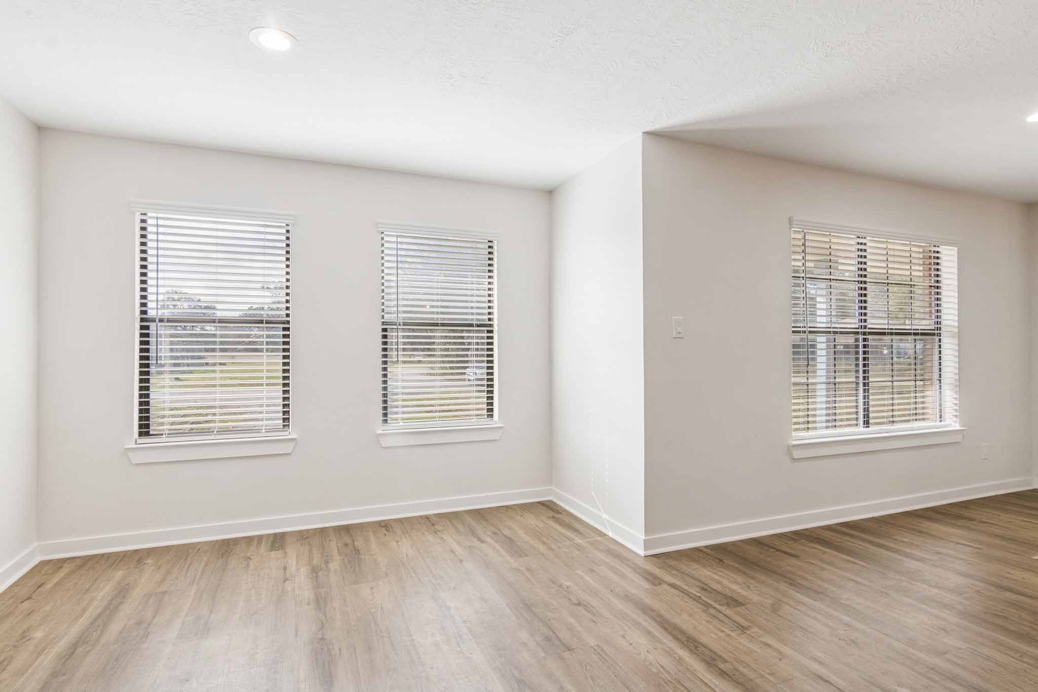 305 James Street Winnie, TX 77665 - Photo 11 of 25 an empty room with wooden floor and windows