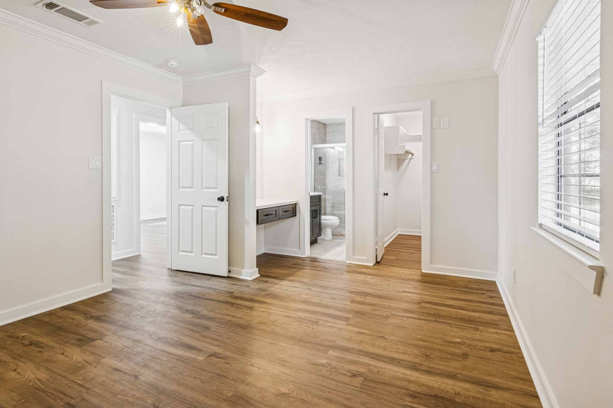 305 James Street Winnie, TX 77665 - Photo 12 of 25 wooden floor in an empty room with a window