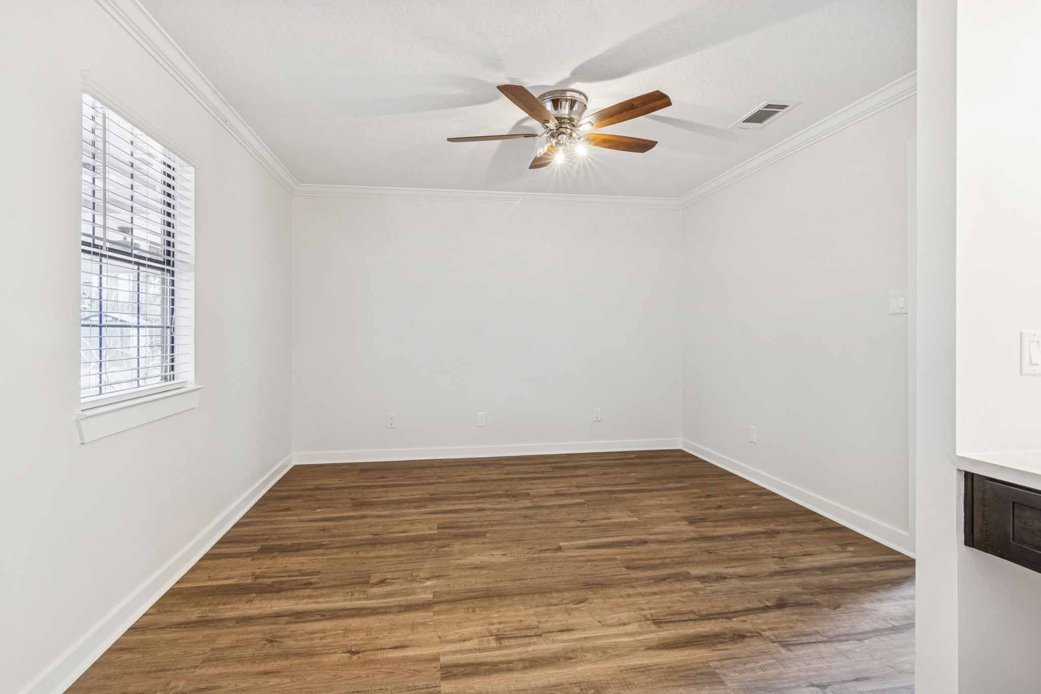 305 James Street Winnie, TX 77665 - Photo 14 of 25 a view of a room with wooden floor and white walls