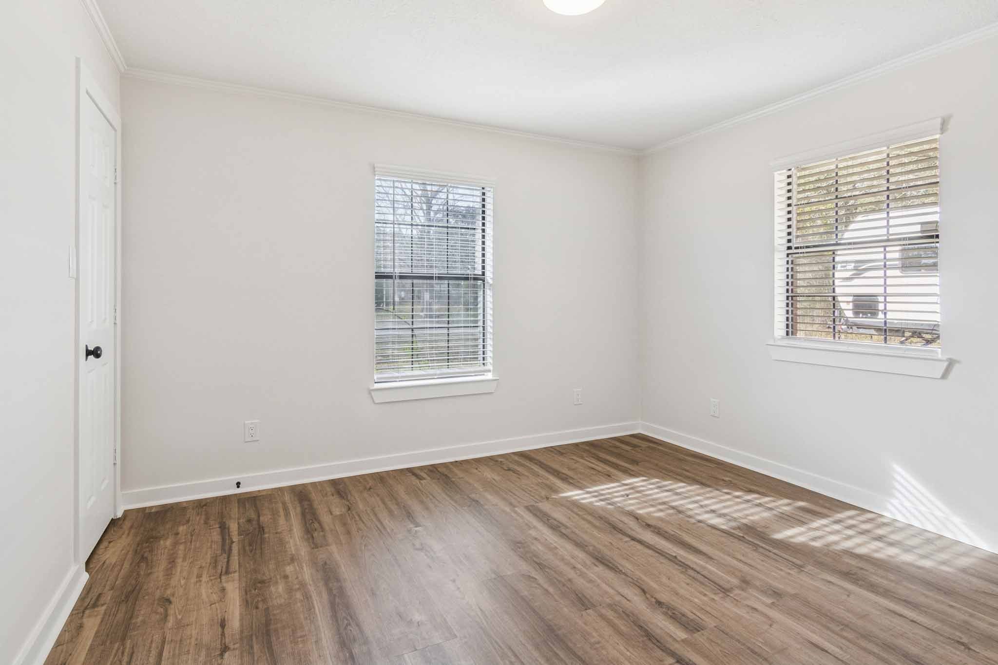 305 James Street Winnie, TX 77665 - Photo 16 of 25 a view of an empty room with wooden floor and a window