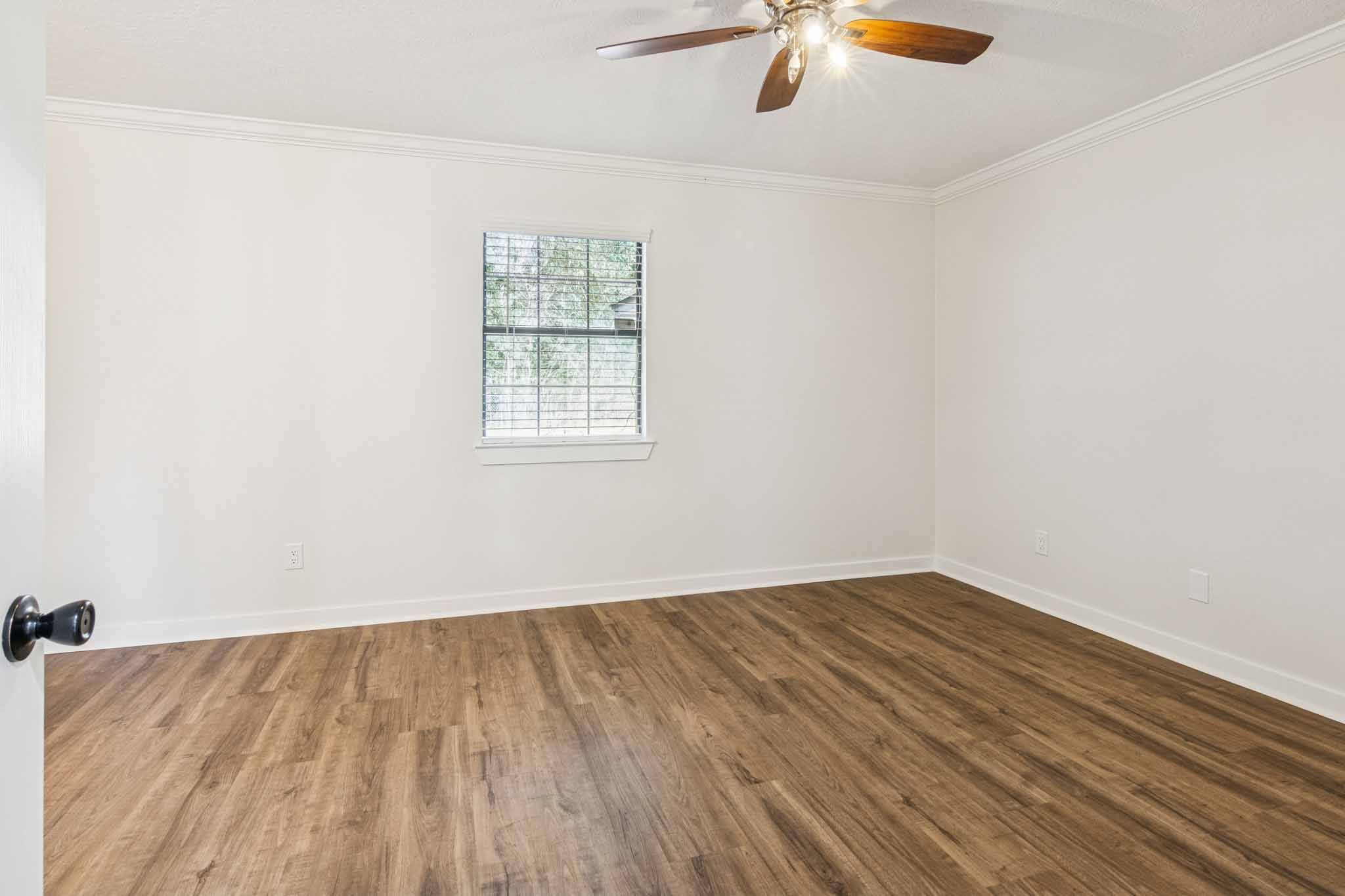 305 James Street Winnie, TX 77665 - Photo 17 of 25 an empty room with a window and wooden floor