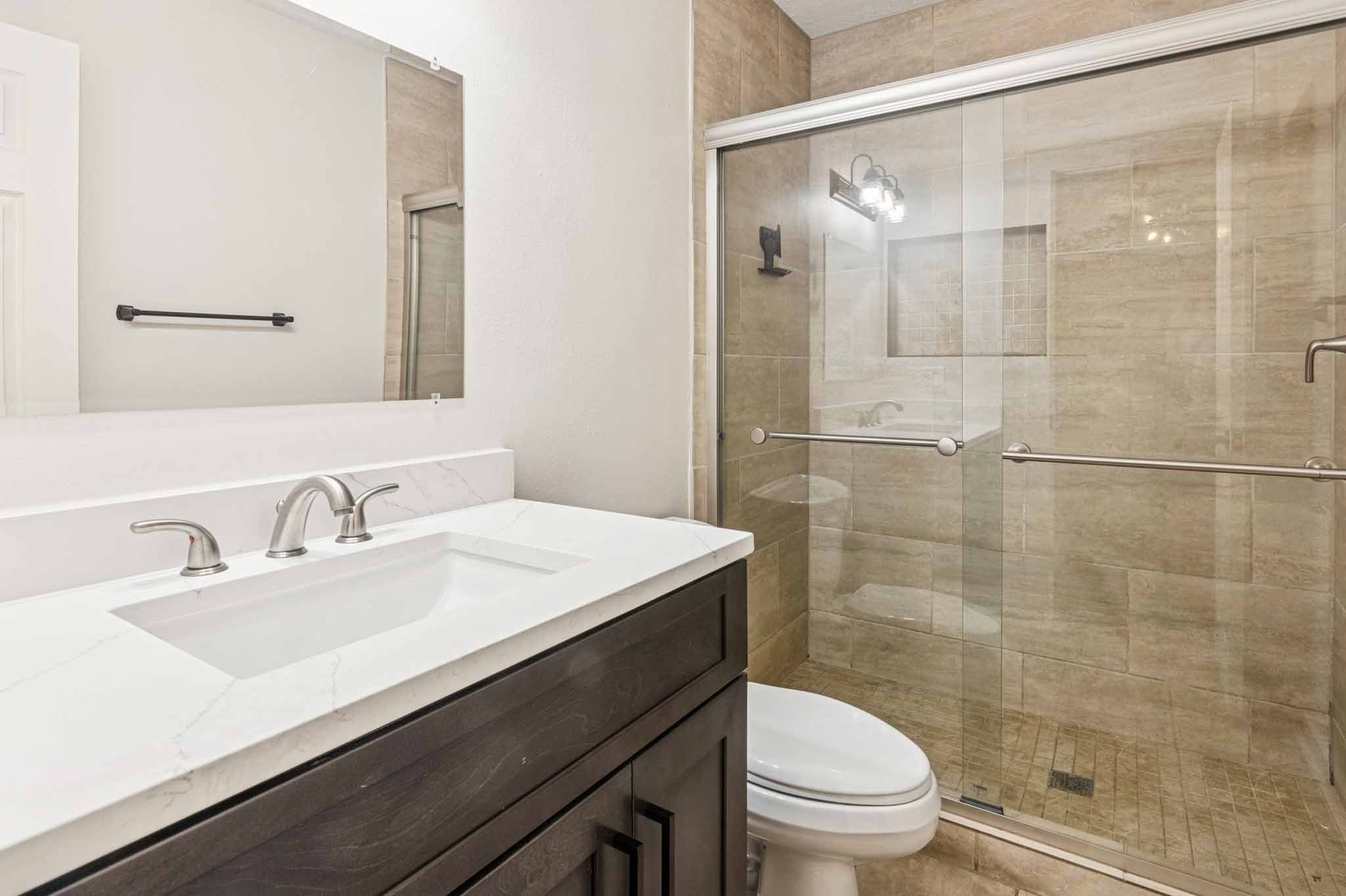 305 James Street Winnie, TX 77665 - Photo 19 of 25 a bathroom with a sink a toilet and shower