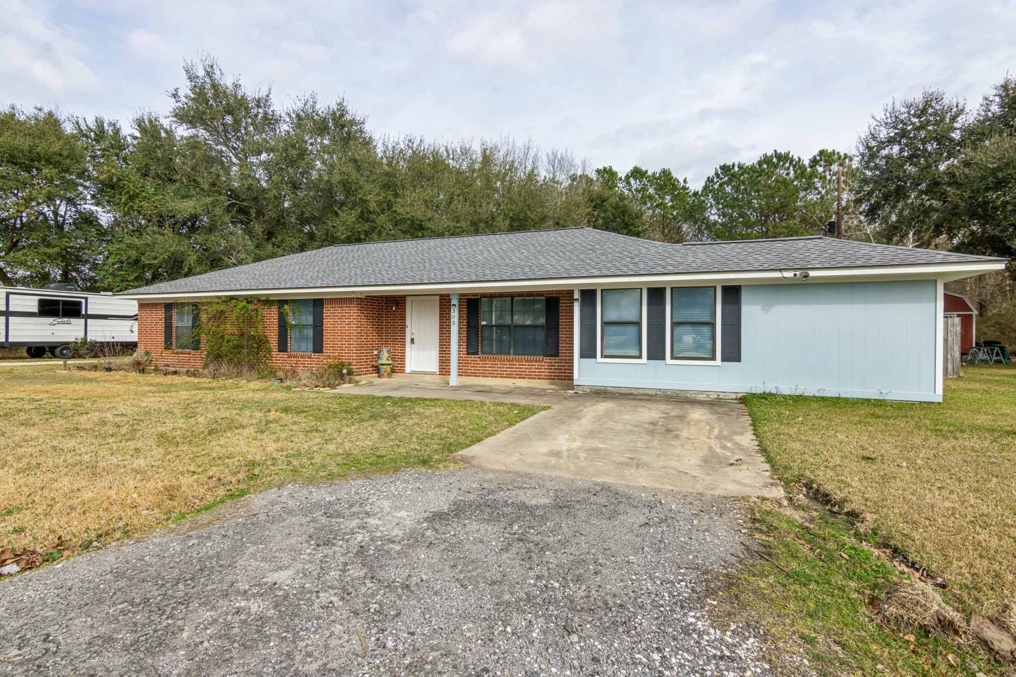 305 James Street Winnie, TX 77665 - Photo 2 of 25 a view of a yard in front of house