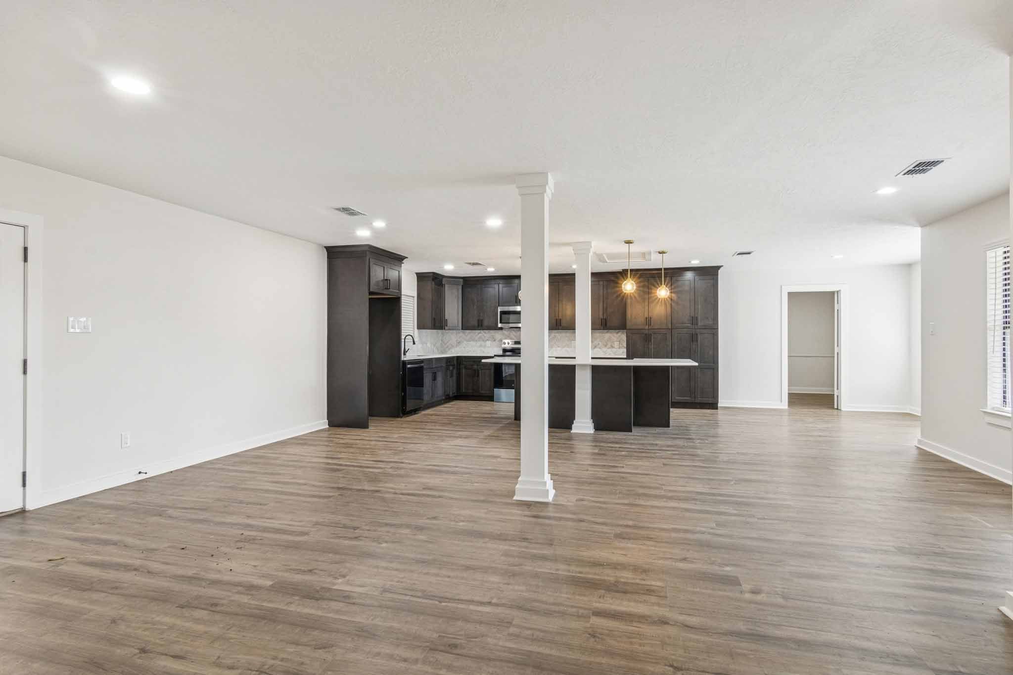 305 James Street Winnie, TX 77665 - Photo 8 of 25 a view of kitchen with kitchen island wooden floor center island and stainless steel appliances
