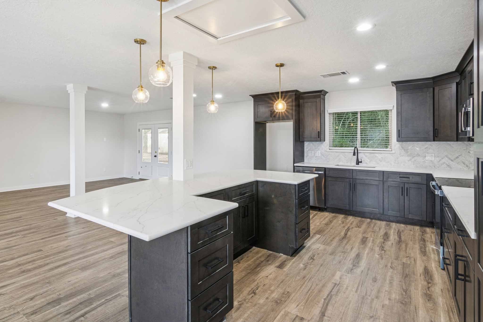 305 James Street Winnie, TX 77665 - Photo 9 of 25 a large kitchen with kitchen island a sink stainless steel appliances and cabinets