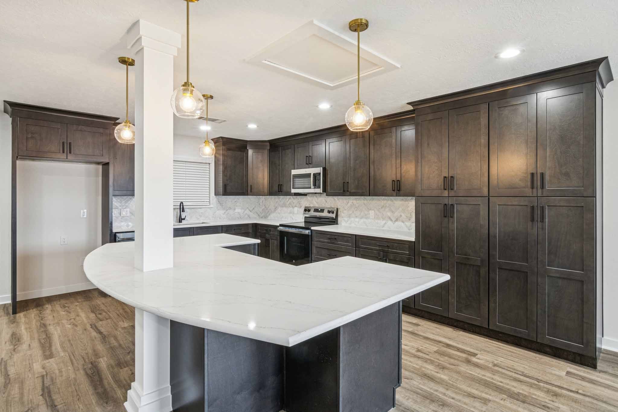 305 James Street Winnie, TX 77665 - Photo 10 of 25 a kitchen with kitchen island a sink stainless steel appliances and refrigerator