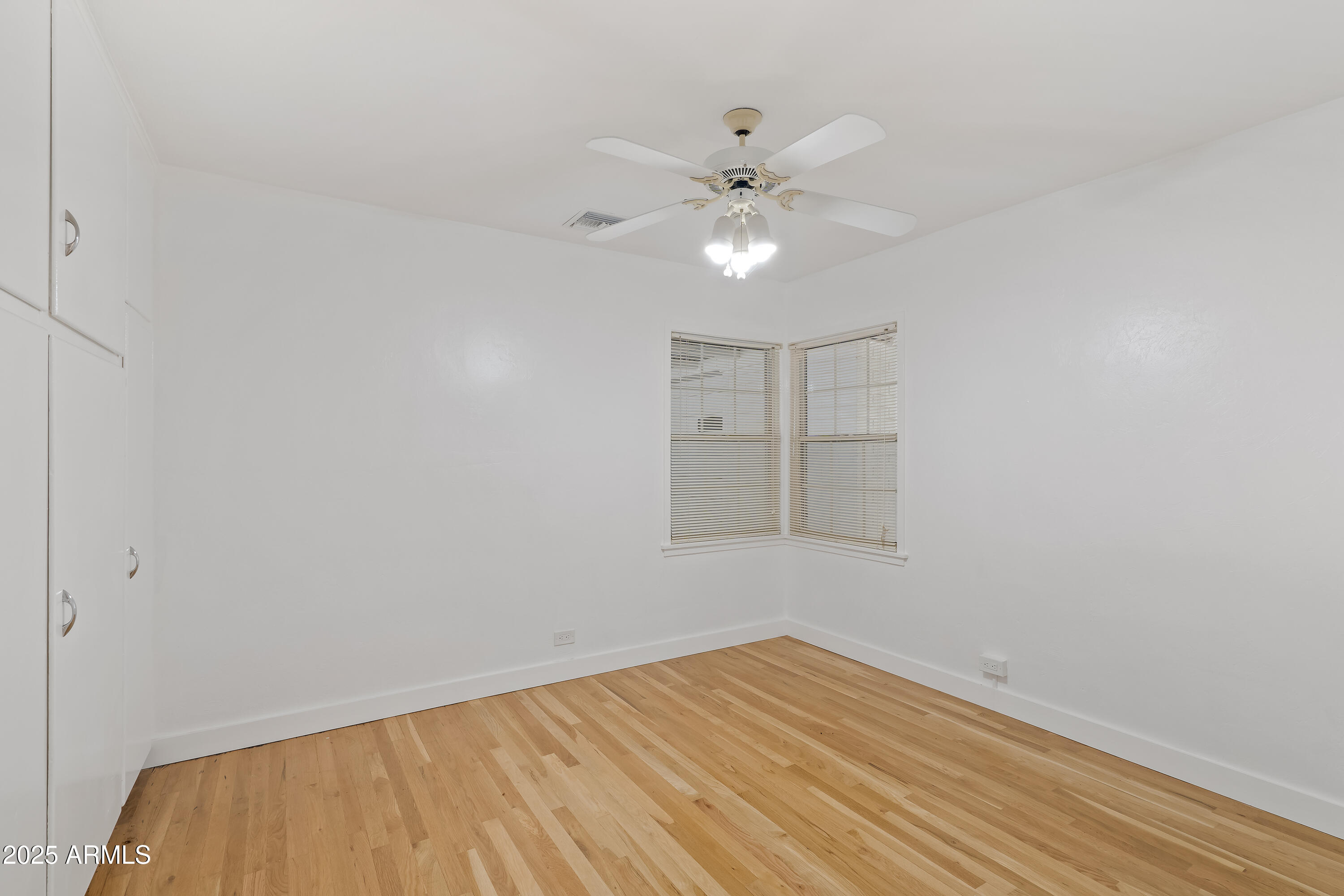 606 Oliver Circle Bisbee, AZ 85603 - Photo 16 of 30 a view of an empty room with wooden floor
