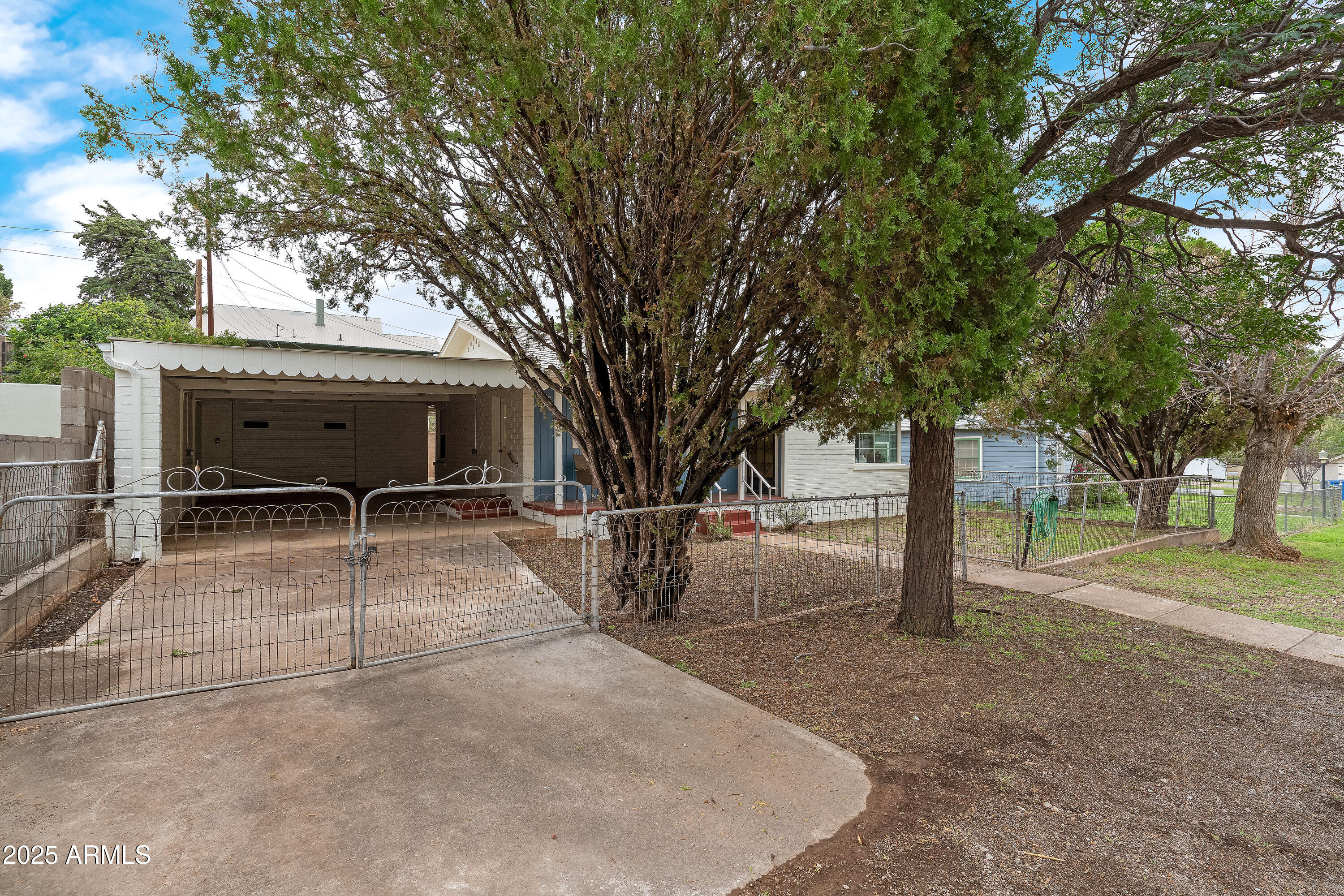 606 Oliver Circle Bisbee, AZ 85603 - Photo 21 of 30 a view of a house with a backyard and a tree