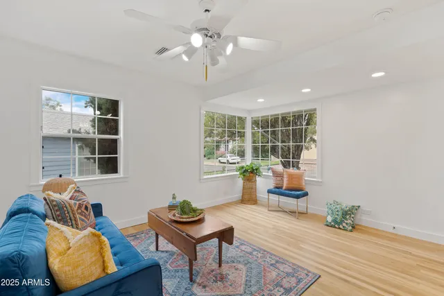 a living room with furniture and wooden floor