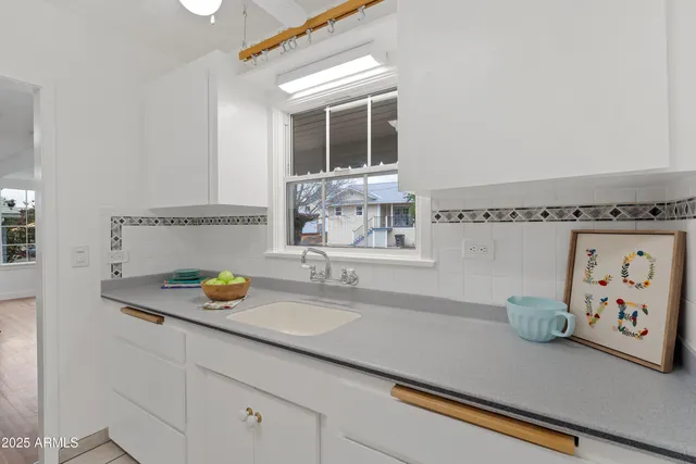 a bathroom with a sink a mirror and a shower