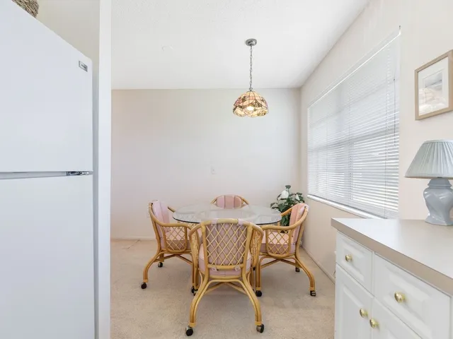 a view of a room with a table and chairs