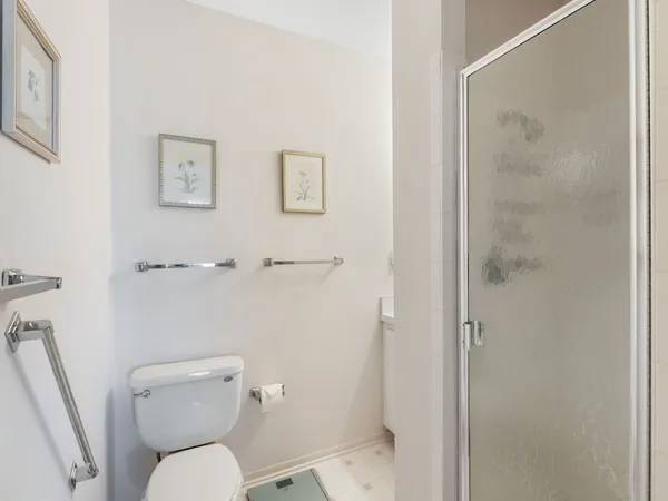 a white toilet sitting next to a bathroom sink