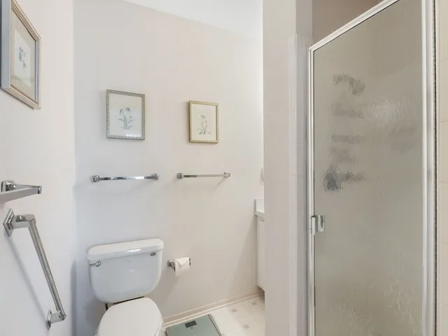 a white toilet sitting next to a bathroom sink