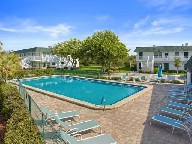 a view of a swimming pool and lounge chairs