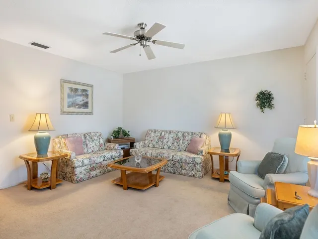 a living room with furniture and a lamp